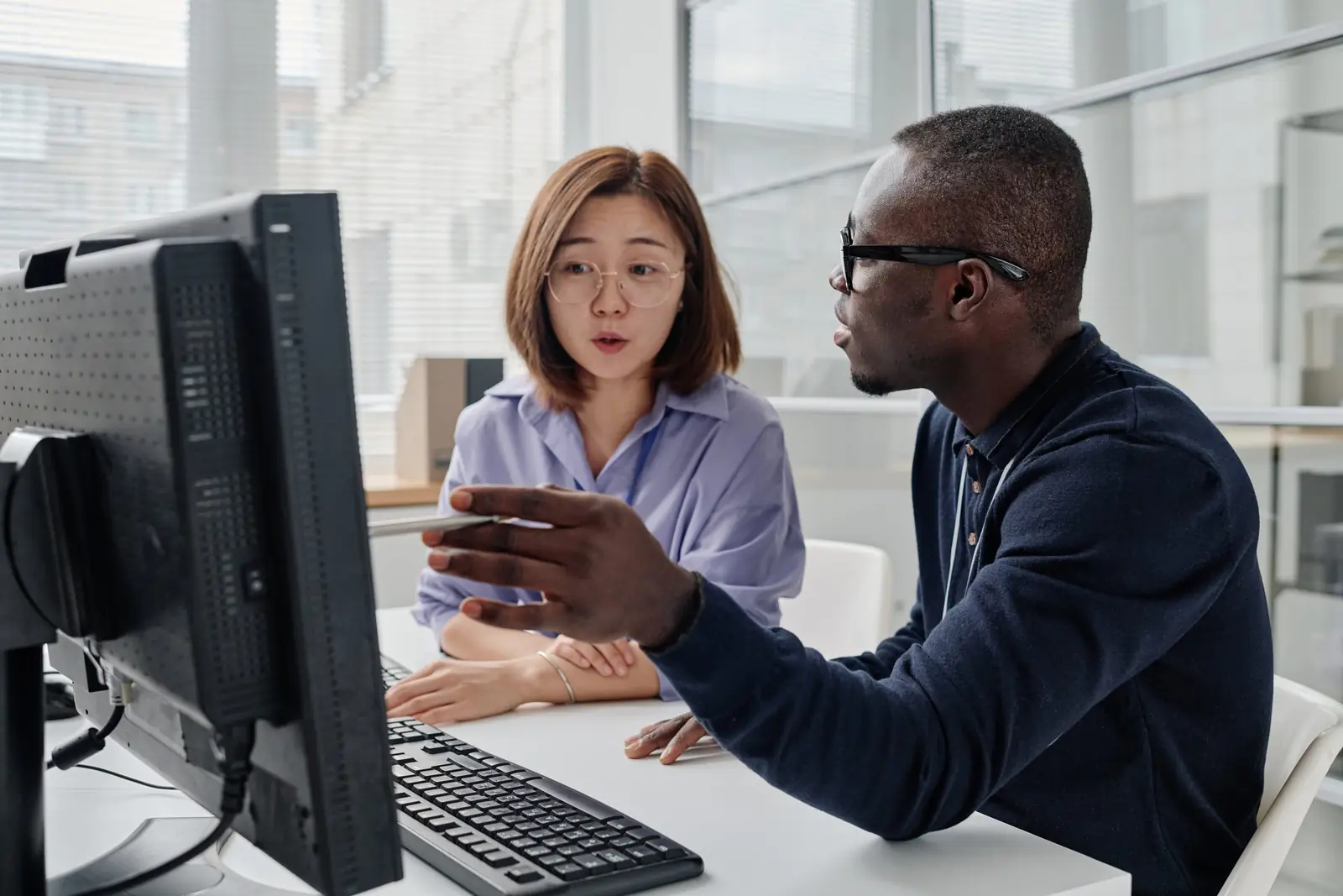 A developer walking a colleague through the software they are building